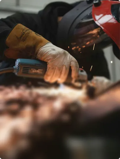 Welder working with a grinding machine